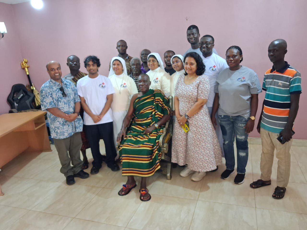 The FutureBright team, hospital sisters, and volunteers with the chief of Abira in traditional kente robes