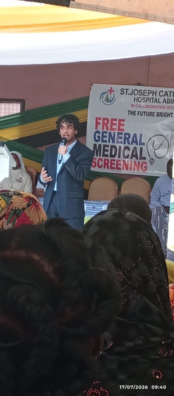 FutureBright founder Nathan Francis addressing the community at the Abira screening, beneath the partnership banner