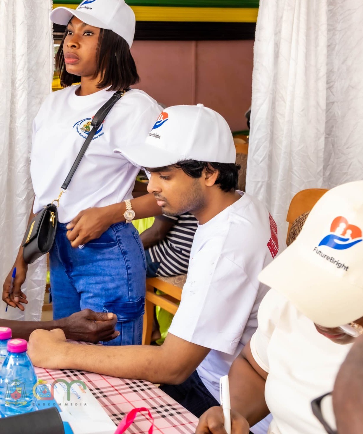 Nathan Francis fitting a blood-pressure cuff on a patient at the Abira screening